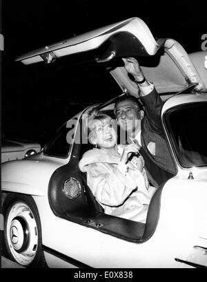 Actress Catherine Deneuve in a sports car with man Stock Photo