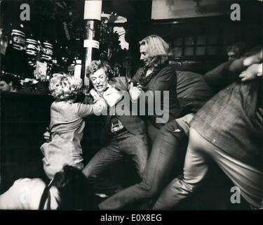 Aug. 08, 1965 - Michael Caine in new film. Michael Caine, star of the successful 'Iporess File', is now making a new film called ''Alfie'', at Twickenham Studios. Shots for the film were taken today in a Brixton public house. Jane Asher also stars in the film. Photo shows Andre Camreson (right) and Marilyn Gothard 9left), with Micheal Caine, during the filming of a brawl scene in a Brixton public house today. Stock Photo