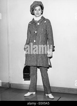 Dec. 7, 1965 - Paris, France - Ballet dancer GERALDINE CHAPLIN wearing a checkered outfit prepares to board a plane at Orly Airport to New York, for the premiere of the film, 'Doctor Zhivago.' Stock Photo