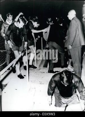 Oct. 10, 1965 - Rome Soccer crowds pelt Chelsea players during theirinter-cities fairs Cup-title in Rome.: Chelsea manager Tommy Docherty and his left-winger John Boyle were both knocked out by objects thrown by the Italian soccer crowd during the Inter-Cities Fairs cup-tie against the Italian soccer team Roma in Rome on Wednesday night. Photo shows some of the Chelsea players duck their heads to avoid objects thrown at them by the crowd as they walk to the tunnel for the interval. Stock Photo