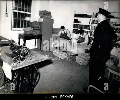 Jan. 01, 1966 - MAIL BAGS ARE SEWN UNDER MAXIMUM SECURITY A uniformed BM Prison officer stands by as mail bags are sewn in the workroom of the new maximum security wing at Durham Gaol, where the of the Great Train Robbers are amongst the prisoners detained. Part of the library of books is seen in the background. Maximum Security precautions are in forces at all times. Stock Photo