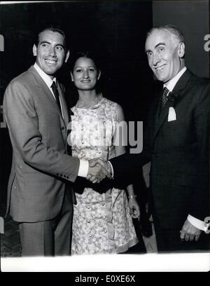 Jul. 07, 1966 - Santana the New Wimbledon Champion Attends Cocktail Part at the Spanish Embassy: Manuel Santana, of Spain, the new Men's Singles Wimbledon Champion, last night attended a cocktail party with his wife Maria at the Spanish embassy in Belgrave square, London. Photo shows the new Wimbledon Champion Manuel Santana pictured with his wife Maria and the Spanish Ambassador the Marques de Santa Cruz when they attended the cocktail party at the Spanish Embassy last night. Stock Photo