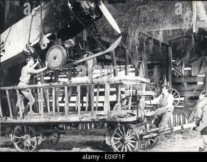 Aug. 09, 1966 - The Bells of Hell top ting-aling-a-ling: Gregory Peck (second from right) and actors of the film under production ''The Bells of Hell go ting-aling-a-ling'' practise loading a model of a First World War plane upon a cart wher it is , wings dismantled, covered with hay, in order to be smuggled across the border. The fantastic script calls for such elaborate preperations as the plane is to be used in a raid on the German Zeppelin works. Stock Photo