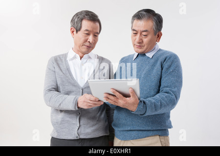 two old men using a tablet Stock Photo
