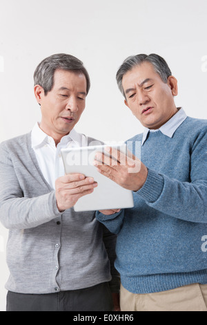 two old men using a tablet Stock Photo