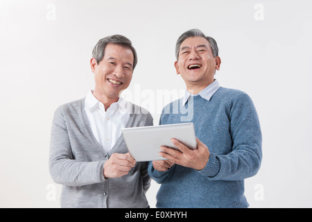 two old men using a tablet Stock Photo