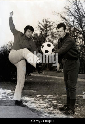 Singer Roy Black and soccer champion Franz Beckenbauer kicking a ball Stock Photo