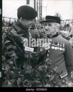 May 05, 1967 - PREPARATIONS FOR THE CHELSEA FLOWER SHOW. PHOTO SHOWS:- PRIVATE GLYNN BENSON, of the famous Red Devils Para Regt. pins a ''Red Devil'' rose, grown by Dickson's of Belfast, to the jacket of 84-year old Chelsea Pensioner, C.S.M. George Arthur Green, of Crossgate, Yorkshire, who served in the S. African War with the Prince of Wales Own Yorkshire Regt - during preparations for the Chelsea Flower Show. Stock Photo