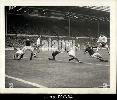 Apr. 22, 1967 - Amateur Cup Final: John Connell of Enfiled (No.8) jumps over Terry Crossie the Skelmersdale United Goalkeeper during a scramble for the ball in the Skelmersdale goal during the Amateur cup final at Wembley Stadium, London today, April 22. The match ended in a 0-0 draw after playing extra time. Stock Photo