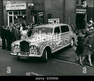 May 05, 1967 - John Lennon's decorated Rolls Royce: Beatle John lennon yesterday took delivery of his re-decorated Rolls Yesterday. It has been painted yellow, with signs of the zodiac and bunches of flowers in red, green and blue on the roof and the doors. The wheels are in red, white, blue and orange. Photo shows John Lennon's decorated Rolls Royce, pictured in Chertsey, Surrey, yesterday. Stock Photo