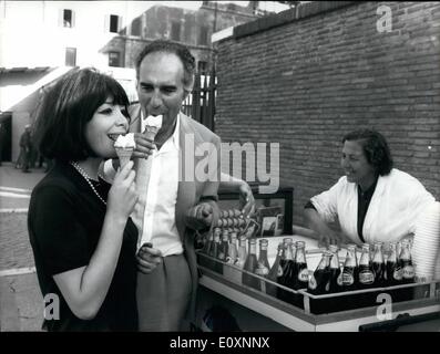 May 05, 1967 - French actor Michel PICCOLI is non in Rome to film ''Diabolik'', that is the new 'star' of the Italian crime-stories. Michel PICCOLI impersonates the figure of the detective who struggles against the criminal. now he received the visit of his wife, the French singer Juliette GRECO?. OPS: Juliette Greco and her husband Michel PICCOLI taste an ice-cream outside the Roman Forum. Stock Photo