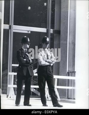 Aug. 08, 1967 - Machine Gun attack on U.S Embassy in London. A massive hunt was being launched today for the gunmen who late last night sprayed the American Embassy with machine gun bullets from a passing car. Bullets pierced the window and plate glass doors of the consular offices in Upper Grosvernor Street. Photo shows Two Policemen standing guard outside the consular wing in Upper Grosvenor Street this morning. Above them can be seen two of the bullet holes, made by the gunmen. Stock Photo