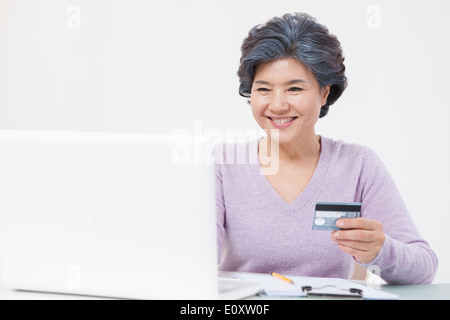 an old woman shopping online Stock Photo