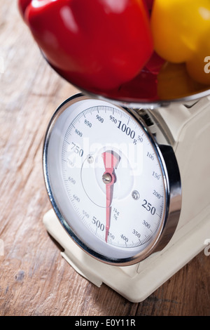 a kitchen scale full of bell peppers Stock Photo