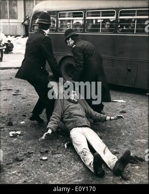 Mar. 03, 1968 - Vietnam Battle: Two policemen drag off a young demonstrator in the Battle of Vietnam in London's Grosvenor Square outside the U.S. Embassy today when thousands of demonstrators besieged the Embassy protesting against the Vietnam war. The Protestors fought with the police and many arrests were made. Stock Photo