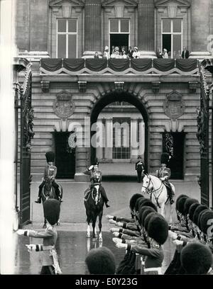 Jun. 06, 1968 - Trooping The Colour Ceremony: The ceremony of the Trooping the Colour took place this morning on Horse Guards Parade to celebrate the official Birthday of the Queen. The colour that was trooped was that of the 2nd Battalion Coldstream Guards. Photo Shows H.M. The Queen takes the salute from the forecourt of Buckingham Palace as the 2nd Battalion Coldstream Guards march past, on the balcony in the background can be seen other members of the Royal family and children watching the parade. Stock Photo