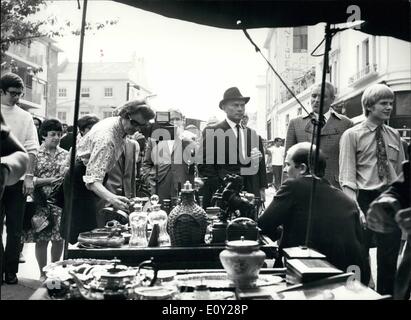 Aug. 24, 1968 - August 24th 1968 Yul Brynner does location shots in Portobello Market for his new film. Film star Yul Brynner is to star as a tough secret agent in a new British hard hitting film, The File of the Golden Goose today he was in London's famous Portobello Road Market for the filming of location shots. Photo Shows: Yul Brynner (centre) is pictured at one of the market stalls during the filming of location shots for the new film in London's Portobello Road today. Stock Photo