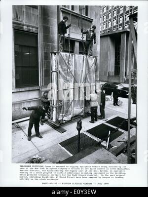 Jul. 07, 1968 - Telephone Switching frame is secured to rigging equipment before being hoisted up the side of the New York Telephone Company's offices at 104 Broad Street in lower Manhattan. Western Electric, the manufacturing and supply unit of the Bell system, is currently working on a crash project to install additional switching equipment in the building, which provides telephone services for the Wall Street district. In the past several months, switching facilities at Broad Street have been swamped at surges in trading activity on the stock exchanges. Stock Photo