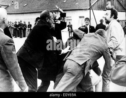 Dec 11, 1968; Dachau, Bavaria, GERMANY; Survivors of Dachau Nazi concentration camp clashed with Left-Wing German students who interrupted the dedication ceremonies at a new memorial at Dachau on Sunday. Former prisoners rushed from their seats to grapple with long-haired youths who ran on to the parade ground with slogans attacking NATO and West German politicians. The demonstrators were from the 'Socialist German Workers' Youth'. Stock Photo