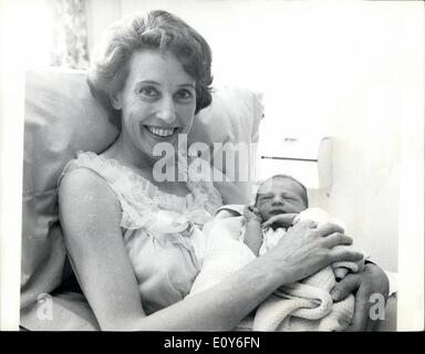 Mar. 03, 1969 - Tennis star Angela Mortimer gives birth to a son.: Former Wimbledon tennis champion, Angela Mortimer, last night gave birth to an 8lb 9oz son, her first child, at St. Teresa's Hospital, Wimbledon. Angela, who is 36, is married to former Davis Cup player John Barrett and they live at Coombe, near Kingston, Surrey. They are maming the baby Michael, Edward. Photo shows Angela Mortimer pictured with her baby son, Michael, Edward, at St. Teresa's Hospital, Wimbledon, today. Stock Photo