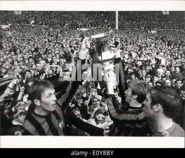 Apr. 26, 1969 - Machester city beat Leicester city 1-0 in the F.A. cup final at Wembley today.: Photo shows scene after the finish of the Cup Final at Wembley this afternon the Manchester City players hold up the cup to show it to thousands of supporters. L-R: Alan Oakes, centre, Colin Bell, and Harry Dowd the goalie. Stock Photo