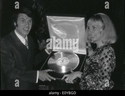Oct. 10, 1969 - Gold Record for Adamo. Salvatore Adamo, the famous singer who is now celebrating his 30 millionth disc was awarded a gold record by Pathe Marconi today. OPS: Salvatore Adamo and his wife Nicole pictured with the gold record. Stock Photo