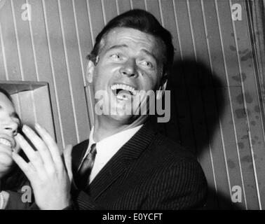 Actor Roger Moore laughing Stock Photo