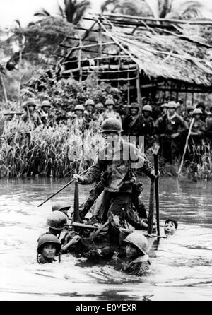 Jan. 01, 1970 - Ba Xuyen, Vietnam - Vietnamese troops ford a canal running through a village in Ba Xuyen, working daily on operations aimed at crushing Viet Cong guerillas in the Ba Xuyen Province. In the 1950's, the US began to send troops to Vietnam, during the following 25-year period, the ensuing war would create some of the strongest tensions in US history. Almost 3 million US men and women were sent to fight for what was a questionable cause. In total, it is estimated that over 2.5 million people on both sides were killed. Stock Photo