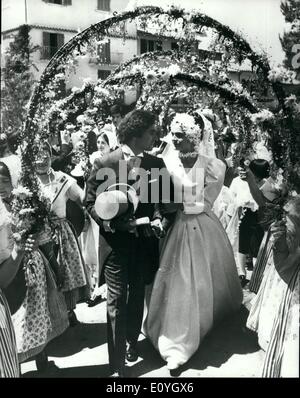 May 05, 1970 - Bridal Archway of Flowers. Michel Raimon, 26-year old son of Alexandre, the hairdresser, and his bride, 22-year-old Evelyne de Beschart, walk through a floral archway, after their wedding over the weekend at Saint Tropes. H.Keystone Stock Photo