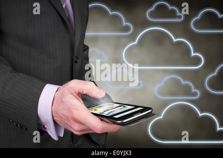 A businessman accessing data on the move over the internet from his mobile phone. Stock Photo