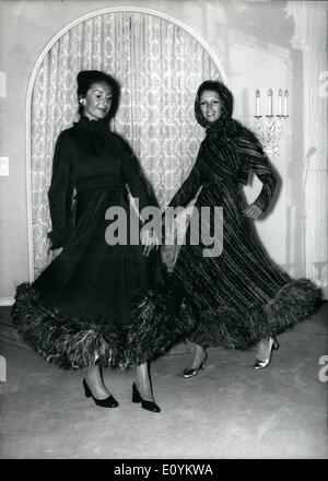 Sep. 09, 1970 - Autumn/Winter-Collection from Adlmuller in Munich: No Mini any more was to be seen when the ''Haus Adlmuller'' in Munich, W. Germany, presented its autumn/ winter collection. The two creations in our picture are typical for the ladylike style of the Vienna couturier. Ilse (left) is wearing an afternoon dress made of brown, pure silk Georgette trimmed with an ostrich-feather boa; the dress is called ''Desiree'' . Evelyn's cocktail dress is named ''Silvermoon'' made of Georgette-brocade with ostrich-fathers at the hem as well. Stock Photo
