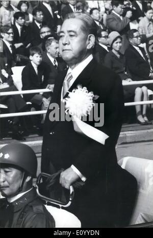 Nov. 11, 1971 - Japan Shows Its Teeth . Ignoring the crush the military review demonstrations by radicals, Japan's Self-Defense Forces marched in parade in Tokyo to celebrate their 21st anniversary, past the grandstands outside the National Stadium in Tokyo. Some 4,600 men from various branches of the services, were saluted by Prime Minister Eisaku Sato, and Naomi Nishimura, Director-General of the Defense Agency. Photo: Prime Minister Eisaku Sato sporting a huge chrysanthemum favor, is driven passed the troops on parade. Stock Photo
