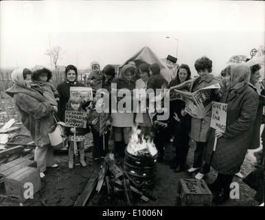 Jan. 01, 1972 - National Coal Strike: Staffordshire Miners aided by wives and children: Miners wives and children supported pickets at Rugely Power Station.This is the first time wives have supported their husbands in the line. Photo shows The wives and children gave support in the pouring rain and warmed themselves on an open fire outside the power station and colliery. Stock Photo