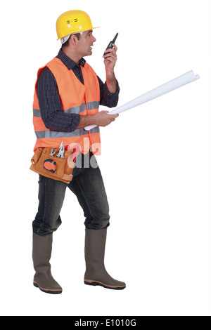 Foreman giving instruction via radio Stock Photo