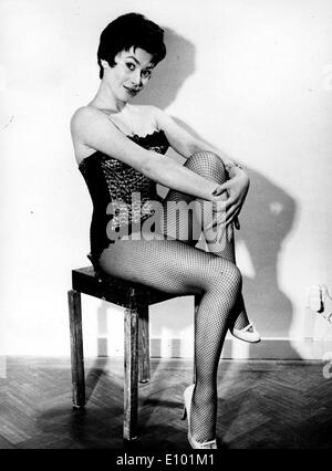English Dancer actress GILLIAN VAUGHAN poses in fishnet stockings and a lacy bustier in a studio Stock Photo