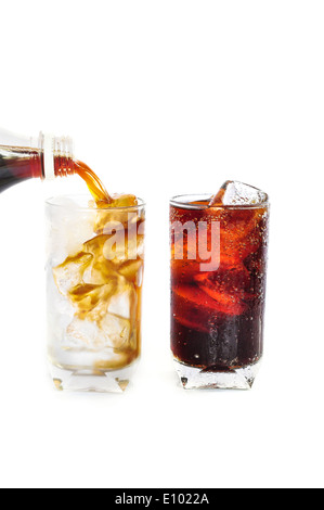 Pouring cola drink from a bottle into glass on white background Stock Photo