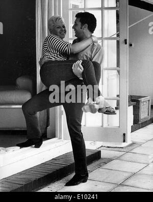 Singer Tom Jones carries wife Linda Stock Photo