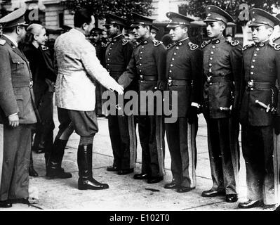 President Juan Domingo Peron inspects troops with wife Eva Stock Photo