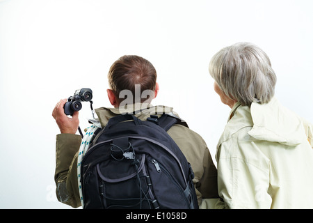 Backs of senior hikers on trip Stock Photo