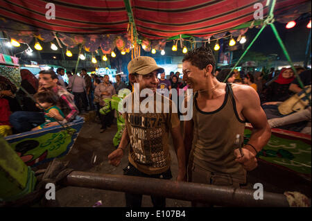 (140520) -- CAIRO, May 20, 2014 (Xinhua) -- Egyptians play at a fair near Sayeda Zeinab mosque for the celebration of 'Moulid Sayeda Zeinab' festival, or the birthday of the granddaughter of Prophet Mohamed, in old Cairo, Egypt, May 20, 2014. (Xinhua/Pan Chaoyue) Stock Photo