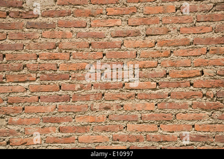 Brick wall made of thin handmade red clay bricks Stock Photo