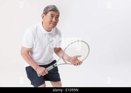 an old man playing tennis Stock Photo