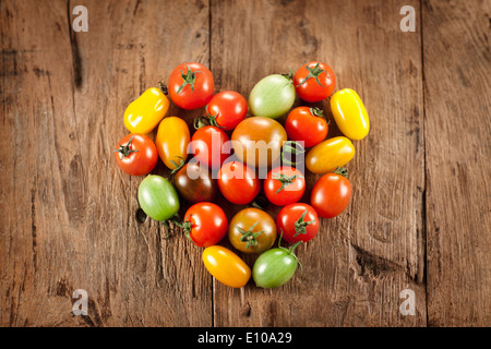 several different color mini tomatoes in a heart shape Stock Photo