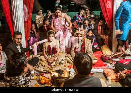 Indian Wedding Ceremony The bride and groom in the centre Photographed in Delhi, India Stock Photo