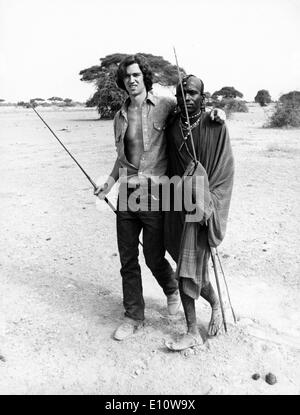 ROBERT KENNEDY JR. and Masai morani walk with arms draped around each other's shoulder, waist as a sign of friendship Stock Photo