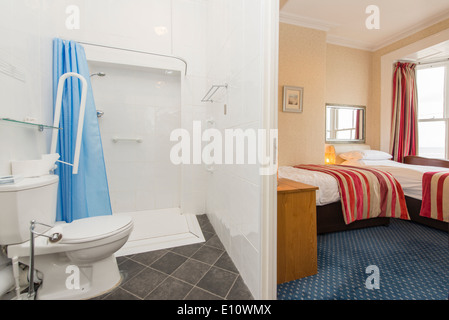 A disabled wheelchair access en-suite toilet and shower in a hotel UK Stock Photo