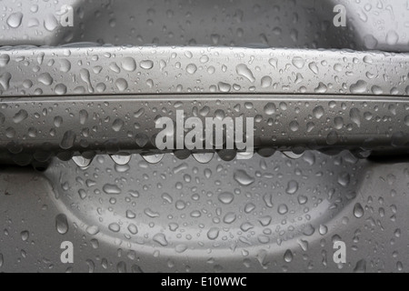 water drops on car door handle Stock Photo