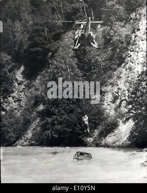 Aug. 13, 1974 - Spectacular Rescue: A highly spectacular rescue operation was carried out near Brug, in the canton of Wallis, Switzerland. A car plunged 23 feet into the fast - running River Rhone. A rescue helicopter arrived on the scene 20 minitus after the accident, and freed the copants, the driver and his wife, from their dangerous situation. The helicopter first rescued the driver, then his wife, while men on the bank held the car with ropes to prevent it being swept away. Photo Shows: The dramatic scene as the driver's wife is rescued by helicopter. Stock Photo