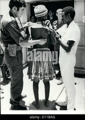 Nov. 11, 1976 - Angolan Refugees continue to cross the border into South West Africa.: Angloan refugees continue to cross the border into South West Africa, and last weekend 3,000 more arrived at the refugee centre in Ovambo, set up by the South African Government. Meanwhile the killing is still going on in Southern Angola as MPLA and supporting forces continue their drive to crush Unita. Photo shows a young Angloan girl refugee sen being given a medical check at the refugee centre on Ovambo. Stock Photo