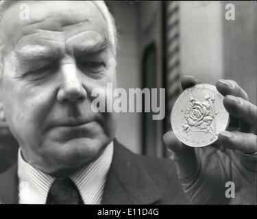 Feb. 02, 1977 - Jubilee Medal: The Philip Spink, Chairman of Spink & Son Ltd., The Old Medalists, examines the first Jubilee medal struck by his company, showing a special hybrid tea rose called ''silver Jubilee'', bred by Mr. Alec Cocker, the Royal rose grower/ The medal was designed by Mr. Leslie Durbin C.B.E., M.V.O., the distinguished silversmith and coin designer. Stock Photo
